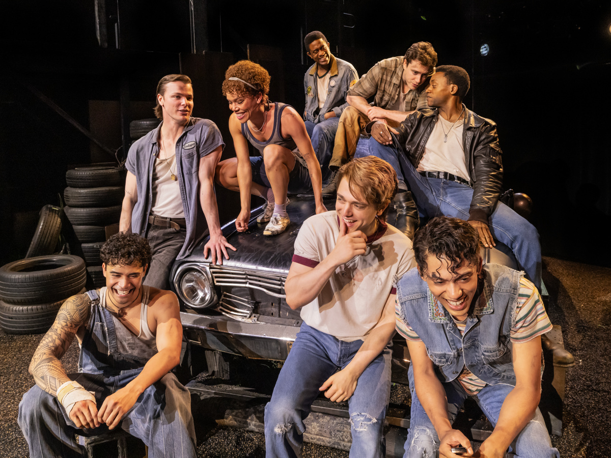 cast members of The Outsiders sit together
