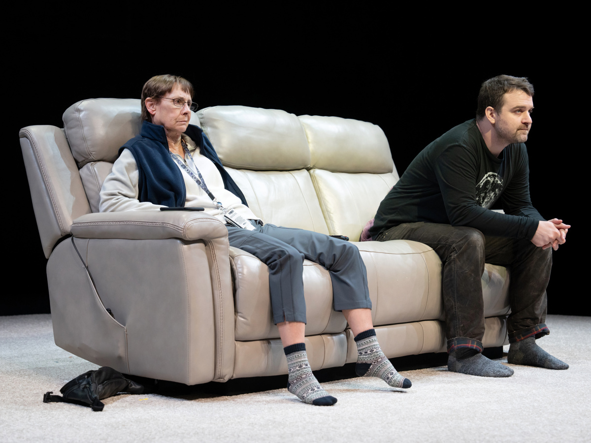 Laurie Metcalf and Micah Stock sit on a couch in Little Bear Ridge Road on Broadway